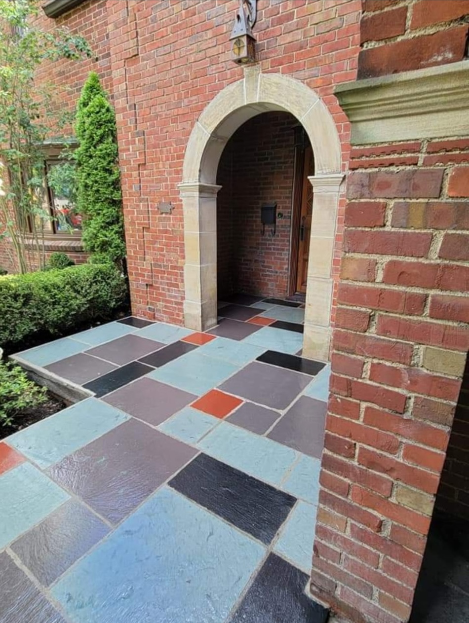 Brick archway with colorful slate walkway
