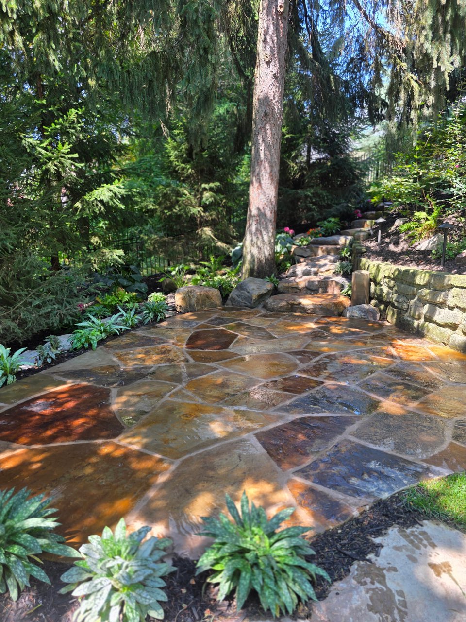 Flagstone patio surrounded by garden landscaping