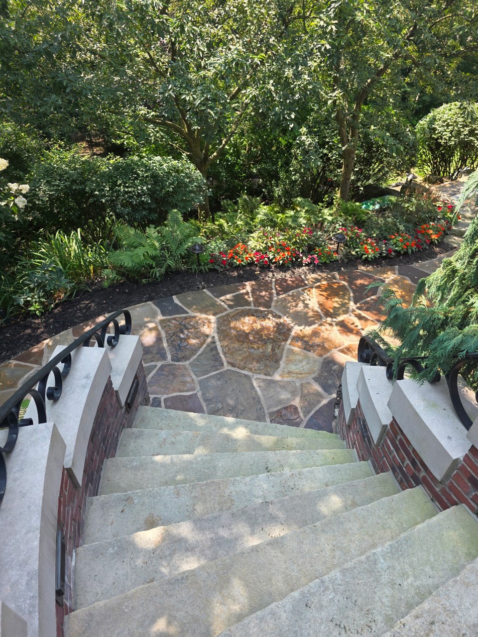 Custom stone steps with brick walls and flagstone patio